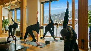 group stretching in Schweitzer's cambium spa yoga space during a wellness session