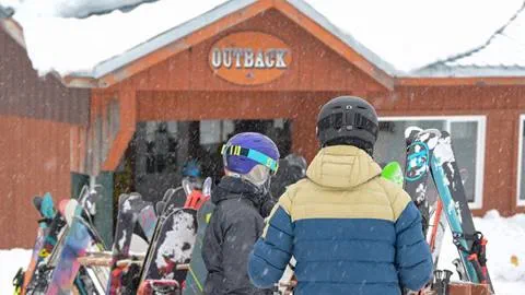 Skiers walking up the The Outback