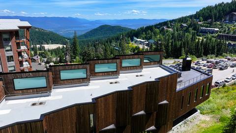 drone view of the humbird hotel at Schweitzer and background of lake pend oreille and the cabinet moutains