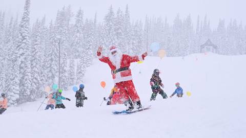 santa skiing with snowy weather and balloons and kids