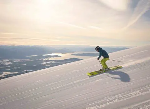 skier on sunny day with lake pend oreille in background